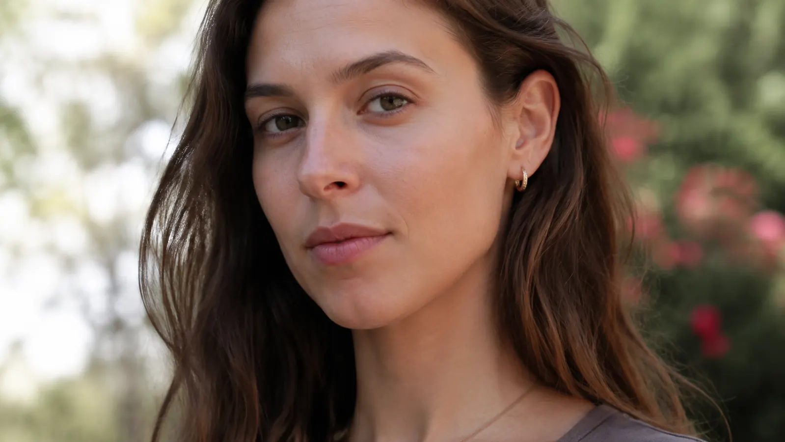 Woman with visibly calm, even-toned skin outdoors in daylight