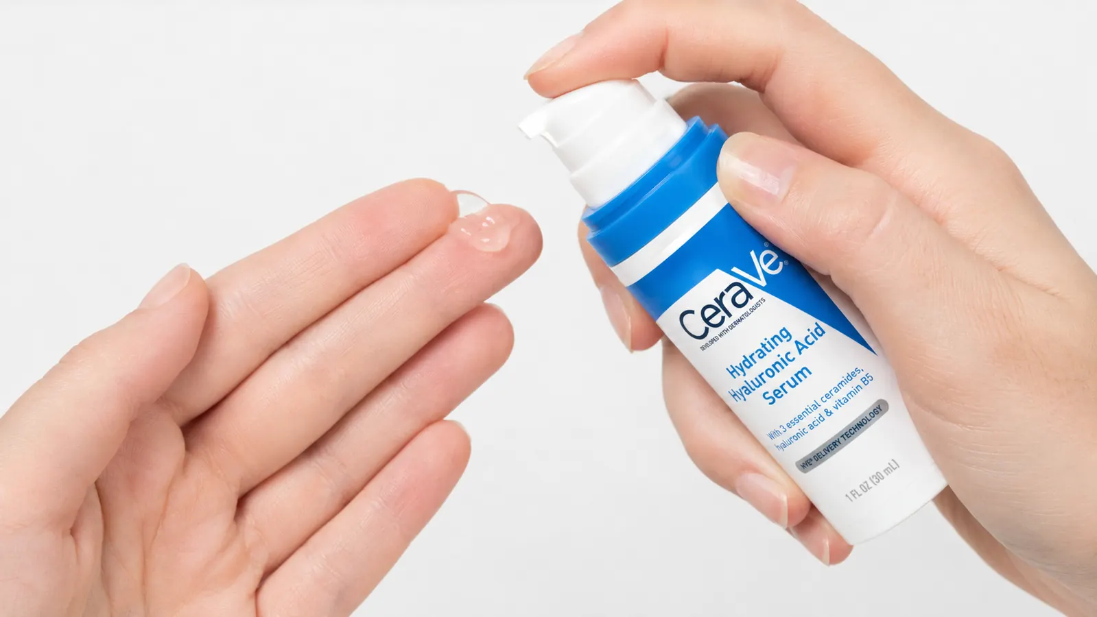 Hand holding the CeraVe Hyaluronic Acid Serum bottle with pump depressed, showing a clear gel serum dispensing onto fingertips
