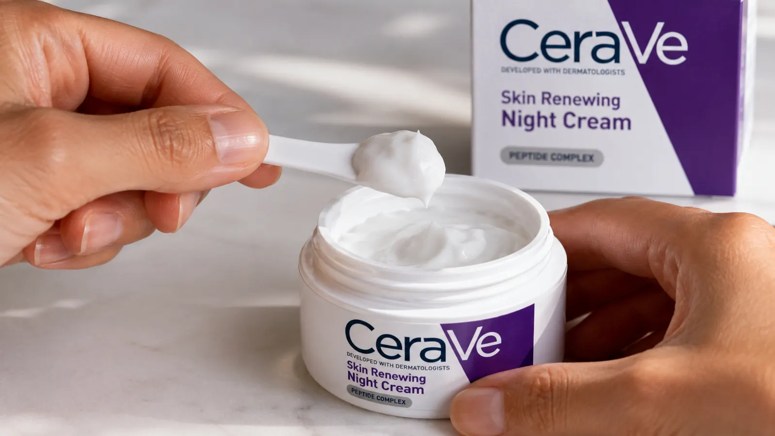 Close-up of CeraVe night cream texture showing thick, smooth consistency on a spatula